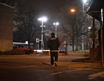 While canvassing in Olney, Tarik Harris crosses the street to survey Lindley Playground, which he says is known to be a location for selling drugs. (Kriston Jae Bethel for WHYY)