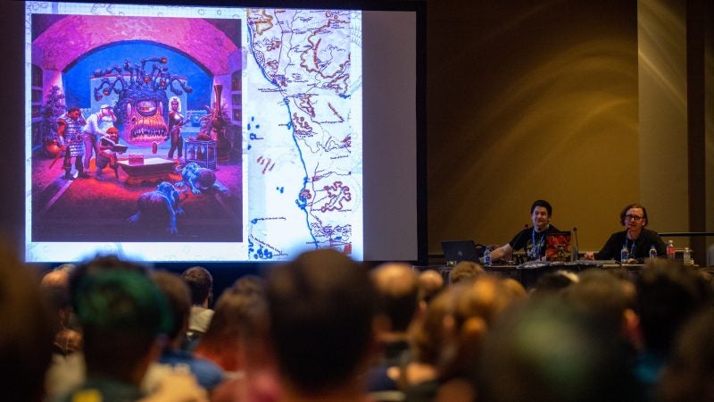 Authors Michael Witwer and Jon Peterson discuss original artwork from a 1980s version of Dungeons & Dragons during a presentation on the visual history of the popular roleplaying game. (Kriston Jae Bethel for WHYY)