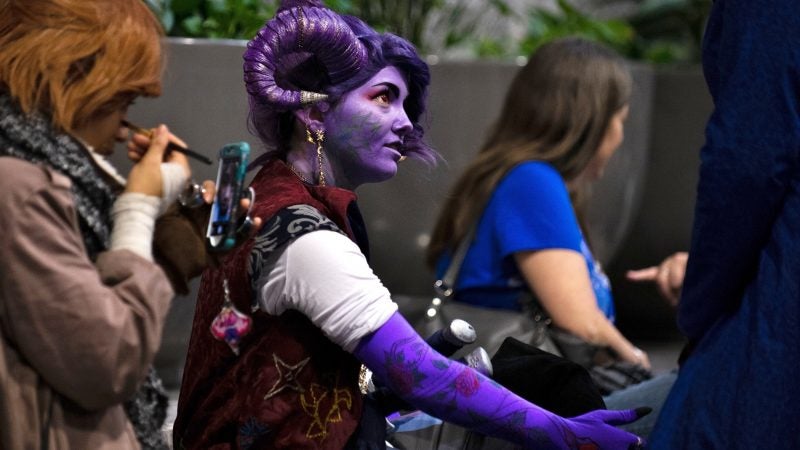 Waya Ciervo waits to participate in a group photo with other cosplayers dressed as characters from the online series 