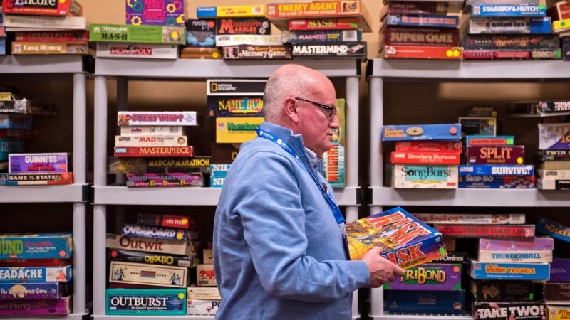 Dennis O'Connor borrows a copy of Risk in the classic board game room at PAX Unplugged. O'Connor and his wife, visiting from Ireland, heard about the convention in their hotel lobby and stopped in to find a gift for their children. (Kriston Jae Bethel for WHYY)