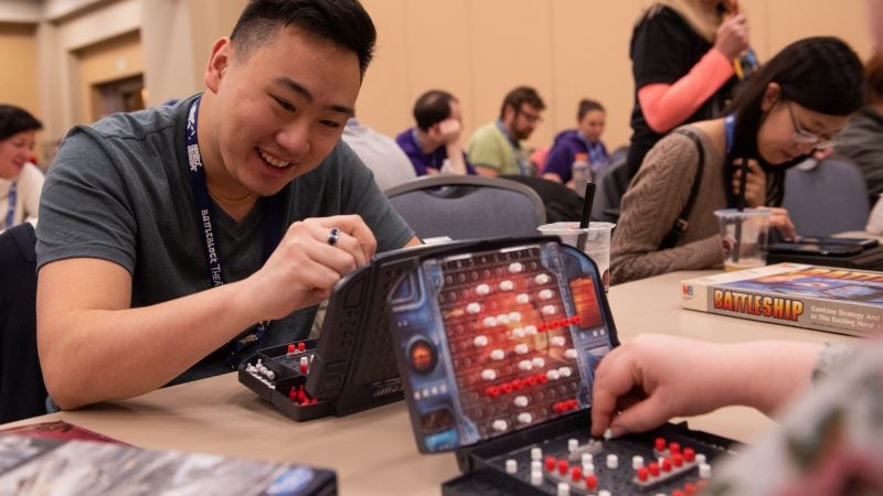 David Chang marks his board during a Battleship tournament at PAX Unplugged. (Kriston Jae Bethel for WHYY)