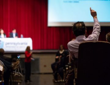 Gary Steinberg raises a hand to ask a question following a presentation by the Pennsylvania Department of Health on the findings of an initial study on the presence of chemicals found in local drinking water. (Kriston Jae Bethel for WHYY)