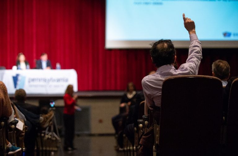 Gary Steinberg raises a hand to ask a question following a presentation by the Pennsylvania Department of Health on the findings of an initial study on the presence of chemicals found in local drinking water. (Kriston Jae Bethel for WHYY)
