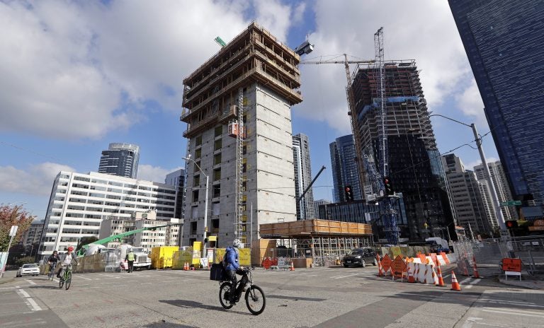 In this photo taken Wednesday, Oct. 10, 2018, construction goes on at the site of a new Amazon building, where space will be provided for a Mary's Place Family Shelter, in downtown Seattle. Amazon.com boss Jeff Bezos' plan to fund preschools in poor communities puts him in the company of America's richest people who have dedicated some of their wealth to education, a legacy that has long challenged the role of poverty and capitalism in philanthropy. (Elaine Thompson/AP)