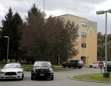 Police cruisers are seen parked near the entrance of the Wanaque Center For Nursing And Rehabilitation, where New Jersey state Health Department confirmed the 18 cases of adenovirus, Tuesday, Oct. 23, 2018, in Haskell, N.J.  (AP Photo/Julio Cortez)