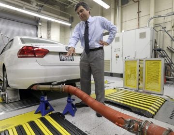 In this Sept. 30, 2015, file photo, John Swanton, spokesman with the California Air Resources Board, explains how a 2013 Volkswagen Passat with a diesel engine is evaluated at the emissions test lab in El Monte, Calif. California officials on Friday, Oct. 26, 2018, blasted the Trump administration's plan to freeze vehicle emissions standards, saying it threatens public health and the environment and was based on a flawed scientific analysis. (Nick Ut/AP Photo, File)