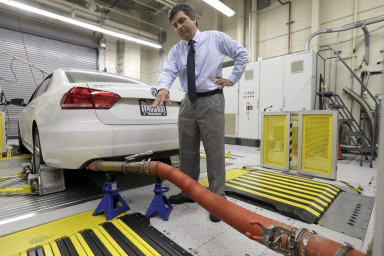 In this Sept. 30, 2015, file photo, John Swanton, spokesman with the California Air Resources Board, explains how a 2013 Volkswagen Passat with a diesel engine is evaluated at the emissions test lab in El Monte, Calif. California officials on Friday, Oct. 26, 2018, blasted the Trump administration's plan to freeze vehicle emissions standards, saying it threatens public health and the environment and was based on a flawed scientific analysis. (Nick Ut/AP Photo, File)