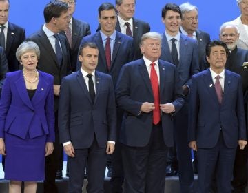 Working visit of Russian President Vladimir Putin to Buenos Aires. G20 Summit. From left to right in the front row: British Prime Minister Theresa May, French President Emmanuel Macron, US President Donald Trump and Japanese Prime Minister Shinzo Abe at the ceremony of joint photographing of all G20 participants. November 30, 2018. Argentina, Buenos Aires. (Photo by Dmitry Azarov/Kommersant/Sipa USA)(Sipa via AP Images)