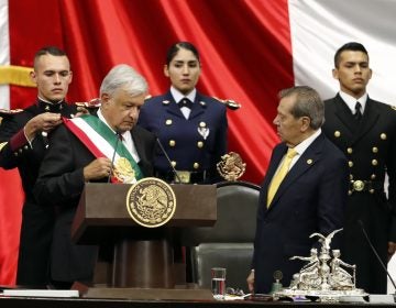 Mexico's new President Andres Manuel Lopez Obrador, (left), receives the presidential sash as Porfirio Munoz Ledo, president of the Congress, (right), looks on during the inaugural ceremony at the National Congress in Mexico City, Saturday, Dec. 1, 2018. (Eduardo Verdugo/AP Photo)