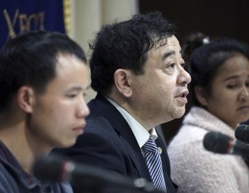 In this Nov. 28, 2018, photo, lawyer Shoichi Ibusuki, (center), attends a press conference on the problems in Japan's technical intern program, with Eng Pisey, (right), Cambodian technical intern and Huang Shihu, left, Chinese technical intern in Tokyo. Ibusuki, lawyer specializing in labor cases and supporting victimized foreign students and interns, called the internship program as a disguise to use trainees as mere cheap labor and should be scrapped and replaced with the new program underway. Japan is set to approve legislation that would officially open the door to foreign workers to do unskilled jobs and possibly eventually become citizens. (Eugene Hoshiko/AP Photo)