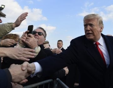 President Donald Trump greets people after arriving via Air Force One at Philadelphia International Airport in Philadelphia, Saturday, Dec. 8, 2018. Trump is attending the Army-Navy football game. (Susan Walsh/AP Photo)