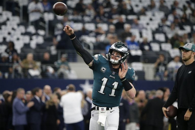 Philadelphia Eagles quarterback Carson Wentz (11) throws a pass throws a pass during warm ups before an NFL football game against the Dallas Cowboys in Arlington, Texas, Sunday, Dec. 9, 2018. (AP Photo/Michael Ainsworth)