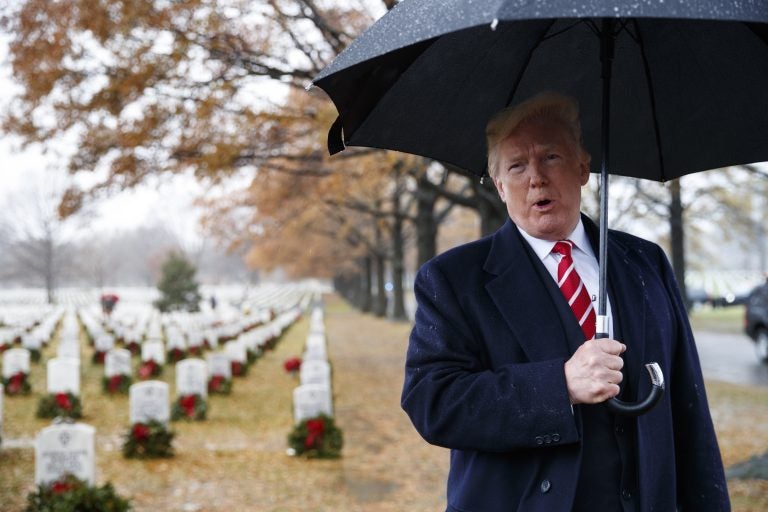 President Donald Trump speaks to media as he visits Section 60 at Arlington National Cemetery in Arlington, Va. on Dec. 15, during Wreaths Across America Day. (Carolyn Kaster/AP)