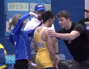 In this image taken from a Wednesday, Dec. 19, 2018 video provided by SNJTODAY.COM, Buena Regional High School wrestler Andrew Johnson gets his hair cut courtside minutes before his match in Buena, N.J., after a referee told Johnson he would forfeit his bout if he didn't have his dreadlocks cut off. Johnson went on to win the match after a SNJ Today reporter tweeted video if the incident, the state's Interscholastic Athletic Association says they are recommending the referee not be assigned to any event until the matter has been reviewed more thoroughly. (Michael Frankel/SNJTODAY.COM viavAP)