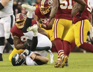 Washington Redskins defensive tackle Stacy McGee (92) sacks Philadelphia Eagles quarterback Nick Foles (9) during the first half of the NFL football game, Sunday, Dec. 30, 2018 in Landover, Md. (Andrew Harnik/AP)