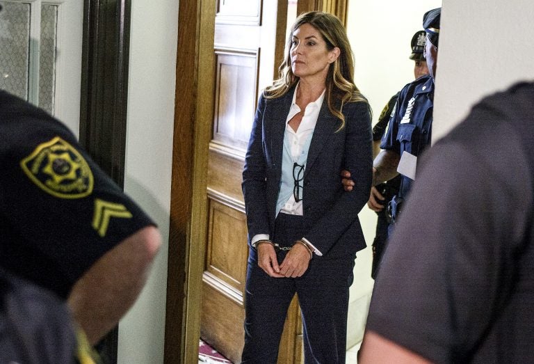 Former Pennsylvania Attorney General Kathleen Kane leaves court in handcuffs after her sentencing at the Montgomery County Courthouse in Norristown, Pa., Monday, Oct. 24, 2016. Kane was sentenced to 10-to-23 months in county jail and 8 years probation. In August 2016, Kane was found guilty of felony perjury and an assortment of misdemeanors related to a leak of secret grand jury materials. (Dan Gleiter/PennLive.com via AP, Pool)