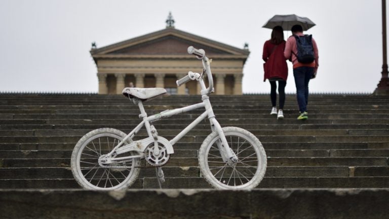 File photo: A white-painted ghost bike is parked on the Philadelphia Art Museum steps, ahead of the Ride of Silence on Wednesday, May 16, 2018. (Bastiaan Slabbers for WHYY)