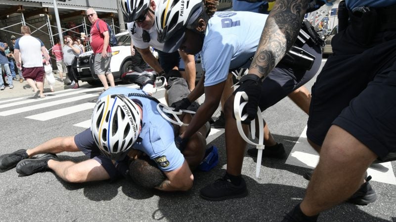 At least three protesters are arrested after sanitation department workers clear out the remains of what started as an Abolish ICE protest camp, near Philadelphia City Hall, on July 31, 2018. (Bastiaan Slabbers for WHYY)