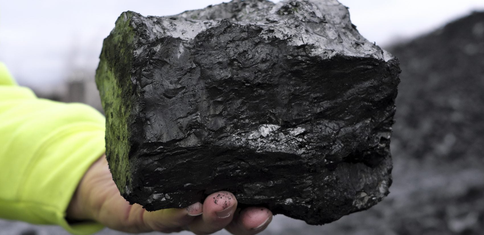 J. Greg Driscoll, president and CEO of Blaschak Coal Corporation, holds a block of coal as he gives a tour of the company's new pit mine Dec. 4, 2018, in Mount Carmel, Pennsylvania. (Matt Smith for Keystone Crossroads)