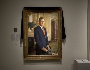 The official portrait of former President George H.W. Bush is draped in black cloth at the National Portrait Gallery in Washington, Monday, Dec. 3, 2018, to mark his passing. Bush will lay in state at the Capitol building this week before being buried in Texas. (AP Photo/Andrew Harnik)