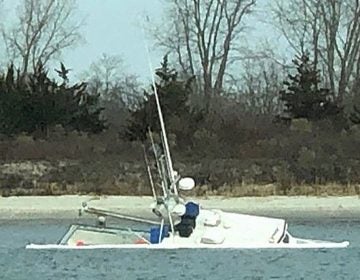 A partially submerged fishing vessel in the Manasquan Inlet Saturday morning. (Image: @thedeskchicken as tagged #JSHN on Instagram)