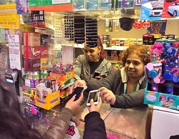 Employees at Nelvin Grocery hold phones for students free of charge. (Courtesy of Ronnie Polaneczky)