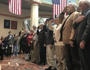 (From left) Hank Heim, William Bonelli, Richard Schimmel and Isaac George salute at a ceremony commemorating the Pearl Harbor attack. (Katie Meyer/WITF)