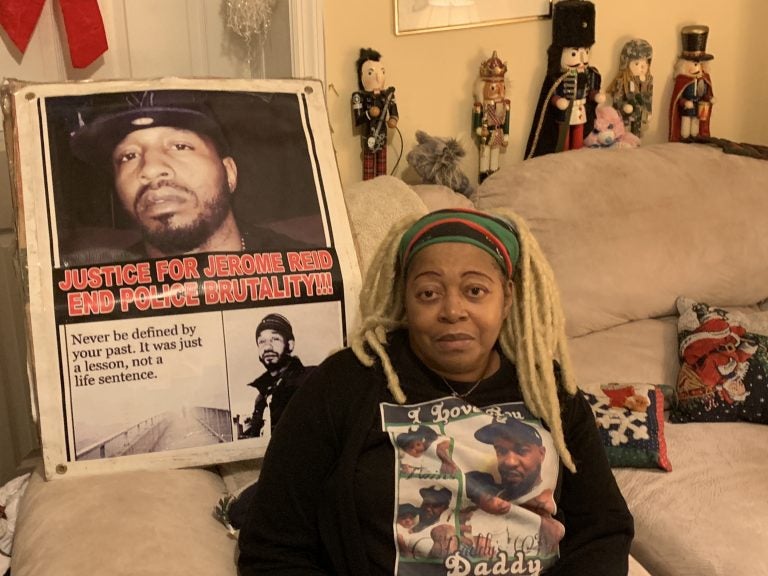 Sheila Reid, whose son, Jerame, was shot and killed by police in 2014, has urged Gov. Phil Murphy to sign a bill requiring New Jersey to investigate all police-involved deaths. She’s sitting in front of a poster made to remember him, that spells his name the way it’s pronounced. (Ang Santos for WHYY)