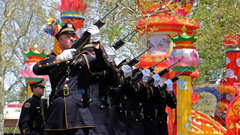 The Philadelphia Police and Fire Honor Guard fire a rifle salute in honor of fallen officers and firefighters during a ceremony at Franklin Square park on May 2, 2018. (Emma Lee/WHYY)