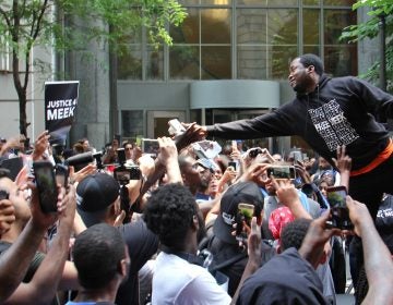 Meek Mill reaches out to supporters outside the Criminal Justice Center on June 18, 2018, before his hearing to ask for a new trial on 10-year-old gun and drug charges. (Emma Lee/WHYY)