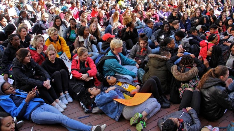 High school students lie down in the City Hall courtyard for a die-in, part of a national day of protest against gun violence on the 19th anniversary of the Columbine school shooting. An even deadlier school shooting in February in Parkland, Florida, brought increased attention to gun control issues. (Emma Lee/WHYY)