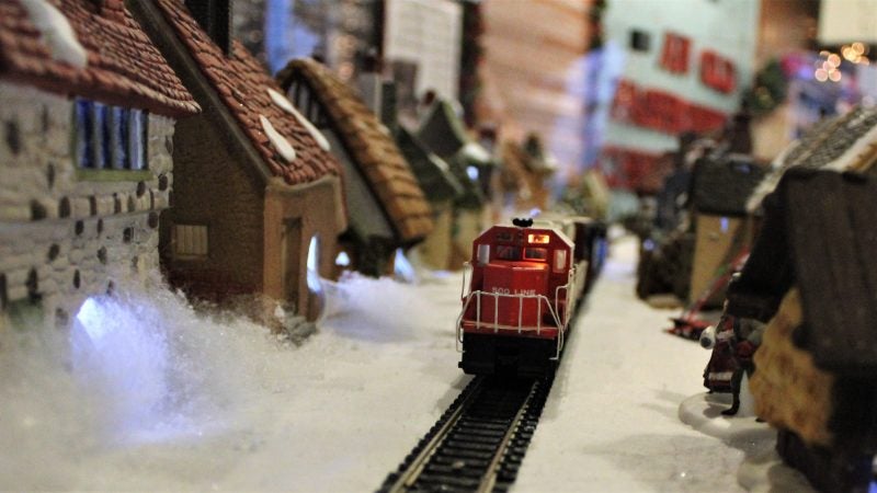 In a gallery in the Carriage House on the property of the Emlen Physick Estate on Lafayette Street, the Mid-Atlantic Center for the Arts and Humanities has a display on an old-fashioned Christmas, including an elaborate village and model train display. (Bill Barlow/for WHYY)