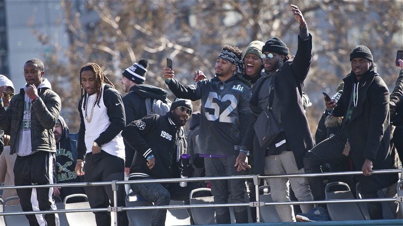 Eagles teammates capture the moment atop the Super Bowl parade bus. (Jonathan Wilson for WHYY)