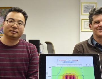 Tieyuan Zhu, (left), and Eugene Morgan of Pennsylvania State University are part of a research team studying carbon storage. They are pictured here with a model that helps explain how carbon dioxide moves through rock underground.
(Amy Sisk/StateImpact Pennsylvania)