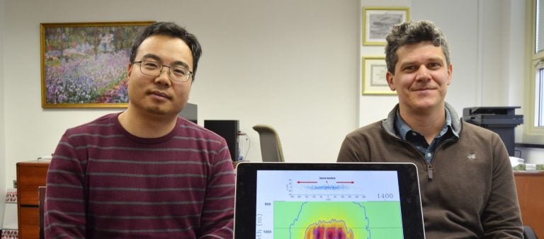 Tieyuan Zhu, (left), and Eugene Morgan of Pennsylvania State University are part of a research team studying carbon storage. They are pictured here with a model that helps explain how carbon dioxide moves through rock underground.
(Amy Sisk/StateImpact Pennsylvania)