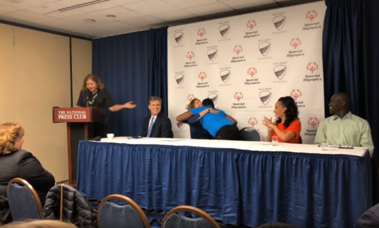 Special Olympics International chairman Tim Shriver sits with Beau Biden Foundation chair Hallie Biden at a press conference announcing a partnership to better protect athletes with intellectual disabilities from abuse. (Beau Biden Foundation/Youtube)