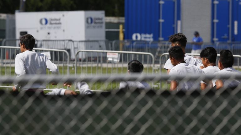 Migrant children run around a track outside at the Homestead Temporary Shelter for Unaccompanied Children in Homestead, Fla. Shelters that house these children are reaching capacity and the federal government is now working to speed releases to sponsors. (Brynn Anderson/AP)