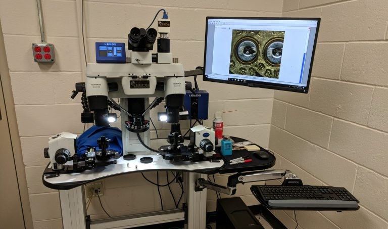 This high-powered microscope allows Berks County investigators to compare marks on shell casings to see if there may be a connection between gun crimes in the area. (Rachel McDevitt/WITF)