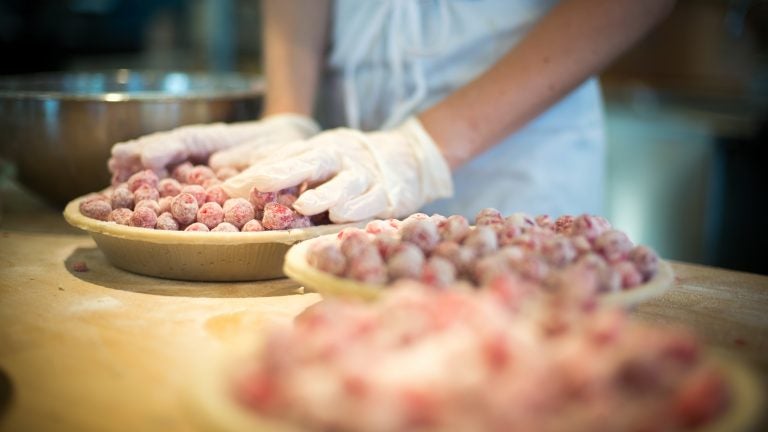 An employee at Grand Traverse Pie Co. in Michigan makes cherry pies. The company has been shipping pies since 1998, when people still had to phone in their orders. (Beryl Striewski/Grand Traverse Pie Co.)