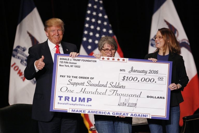 Donald Trump during a January 2016 campaign event awarding a $100,000 check to a veterans charity in Sioux City, Iowa. Trump's use of his personal foundation during the campaign raised legal questions about the foundation's activities. (Luke Sharrett/Bloomberg via Getty Images)