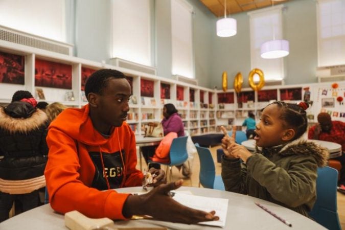 Ivan Perry, 15, is one of the teenagers offering homework help at Logan Library (Neal Santos for PlanPhilly)