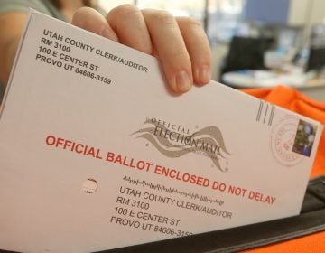 An employee at the Utah County Election office puts mail in ballots into a container to register the vote in the midterm elections on November 6.
(George Frey/Getty Images)