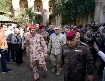 U.S. Marine Brig. Gen. Austin Renforth (center) went with his Iraqi counterpart, Lt. Gen. Jalil Jabbar al-Rubaie (center left), for a tour of Baghdad's most crowded neighborhoods on Friday.
(Mootaz Sami/AP Images for NPR)