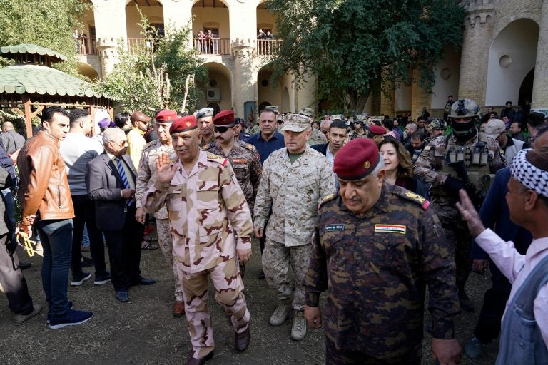 U.S. Marine Brig. Gen. Austin Renforth (center) went with his Iraqi counterpart, Lt. Gen. Jalil Jabbar al-Rubaie (center left), for a tour of Baghdad's most crowded neighborhoods on Friday.
(Mootaz Sami/AP Images for NPR)