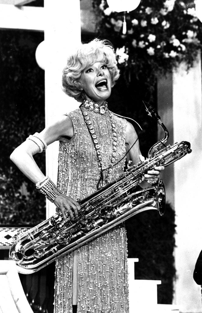 Carol Channing sings and plays the bass saxophone in a scene from the movie "Thoroughly Modern Millie" during rehearsal in Hollywood, Ca., on Nov. 17, 1966.
