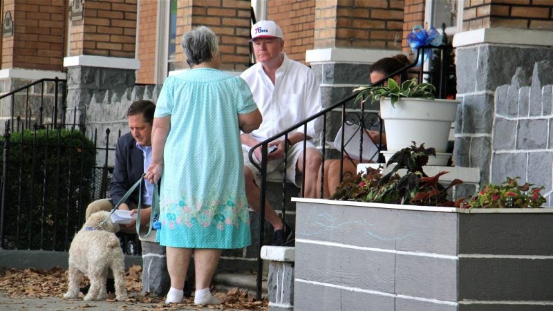 Union leader John Dougherty talks with neighbors while the FBI searches his home on East Moyamensing Street during a raid on Aug. 5, 2016. (Emma Lee/WHYY)