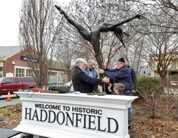Members of the Haddonfield Outdoor Sculpture Trust install 