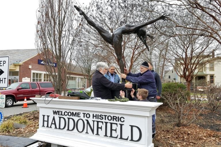 Members of the Haddonfield Outdoor Sculpture Trust install 