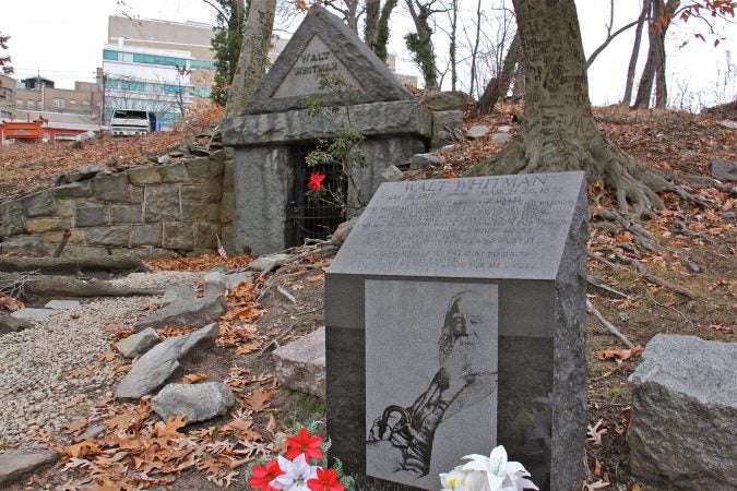 A likeness of Walt Whitman is carved on a memorial marker near his grave site in Camden. (Emma Lee/WHYY)