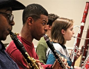 Marquise Bradley, a founding member of the Center City Chamber Orchestra, plays during rehearsal at Settlement Music School. (Emma Lee/WHYY)